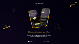 Italpreziosi promotional banner for the launch of the new mobile app. Two gold-framed smartphones display app screens: a product page for a 500g gold bar and a purchase screen with a list of gold and silver bars. At the bottom, the text "La nuova App Italpreziosi è live. Investi in metalli preziosi, direttamente dal tuo smartphone." with download badges for the App Store and Google Play. Dark navy background with golden graphic details.